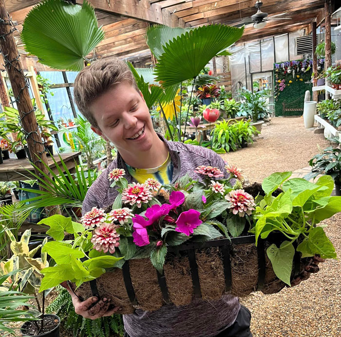 Hocott's associate showing off beautiful plants in store.
